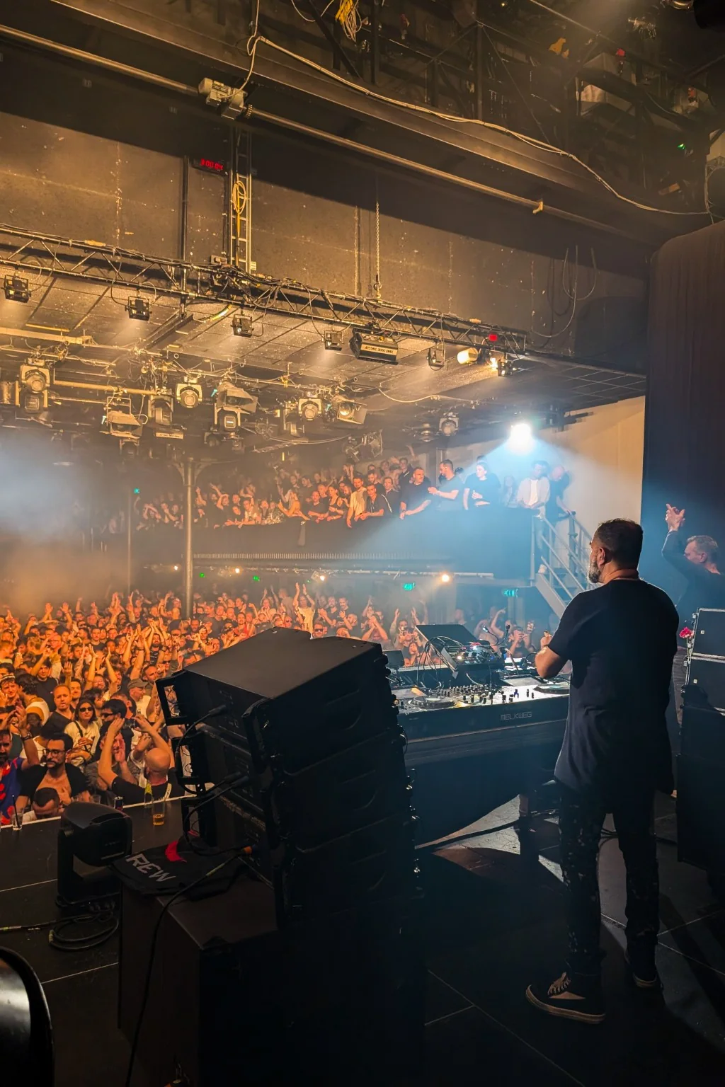 DJ facing a packed club crowd