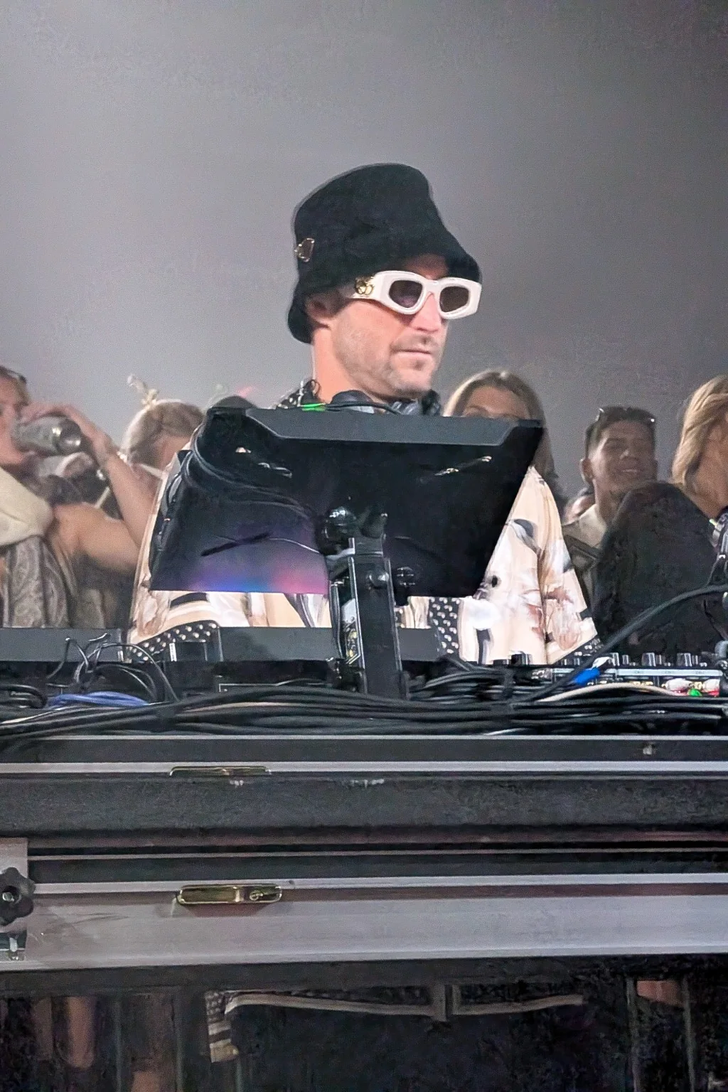 DJ behind equipment in a crowded venue